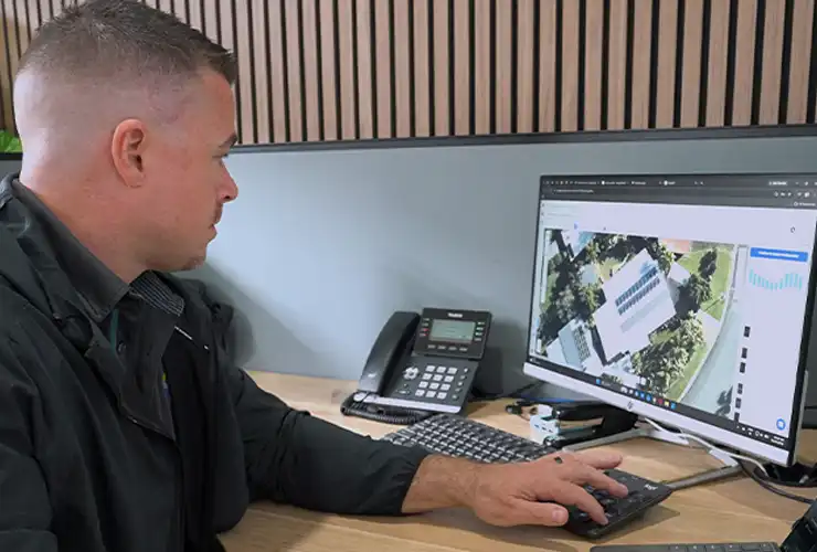 Replenishable Energy team member using aerial roof imagery to design a solar system layout